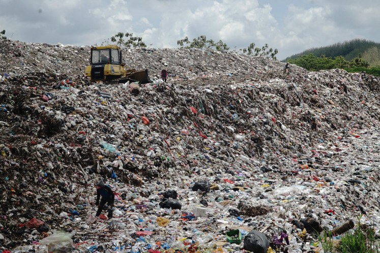 Garbage mountain: A man sorts waste on Oct. 23 at the Segawe landfill in Tulungagung, East Java. The Environment ministry has encouraged regional administrations to make landfills more environmentally friendly.