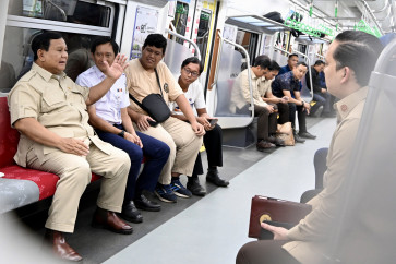 Track record: President Prabowo Subianto (left) rides a commuter train from Manggarai Station on Tuesday, November 04, 2025, on the way to inaugurate the newly built Tanah Abang Baru Station in Central Jakarta, a Rp 309 billion (US$18.47 million) project. 