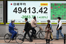 An electronic quotation board displays numbers of the Nikkei Stock Average on the Tokyo stock Exchange in Tokyo on Nov. 5, 2025. Tech companies led a sharp sell-off across Asia on as investors grow increasingly worried about an AI bubble following a rally this year that has seen valuations hit record highs.