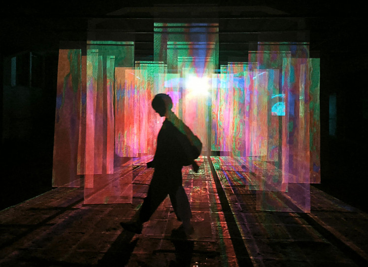 Light pathways: A visitor walks past Resonora, an installation by OSTUDIO X Dearista, on Oct. 3 during .BDG Lights 2025 at Laswi Heritage, Bandung. Featuring at least 25 creators, the city-scale light festival marked the opening of the Bandung Design Biennale 2025, held from Oct. 3-25, and included exhibitions, talks and gatherings of international creative networks.