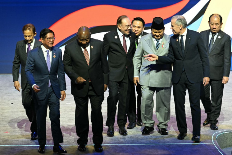 Canada's Prime Minister Mark Carney (second right) talks to Malaysia's Prime Minister Anwar Ibrahim (center) and President Prabowo Subianto (third right), as Philippines' President Ferdinand Marcos Jr (second left) talks to South Africa's President Cyril Ramaphosa (third left) in front of Sultan of Brunei Hassanal Bolkiah (left), after the opening ceremony of the 47th ASEAN Summit in Kuala Lumpur, Malaysia on Oct. 26, 2025.