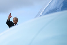 United States President Donald Trump waves on, Nov. 5, 2025, while boarding Air Force One at Miami International Airport, Florida, the US.