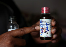 Saddam Mansuri shows a bottle of Coldrif cough syrup, which has been linked to the deaths of multiple children and which he had been giving to his one-year-old child, in Parasia, Madhya Pradesh, India, on Oct. 10, 2025. Coldrif cough syrup has been banned and is being recovered by community healthcare workers amid a door-to-door campaign to spread awareness and recall them.