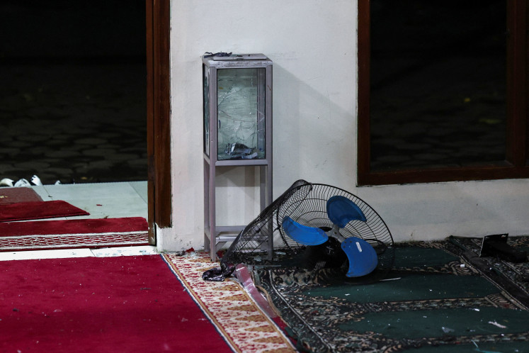 A damaged alms box and a fan lie on the ground in the area after an explosion occurred at a mosque inside the school complex of state high school SMAN 72 in Kelapa Gading, North Jakarta, November 7, 2025.