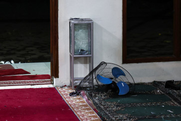 A damaged alms box and a fan lie on the ground in the area after an explosion occurred at a mosque inside the school complex of state high school SMAN 72 in Kelapa Gading, North Jakarta, November 7, 2025.
