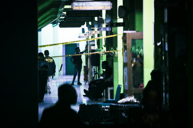 Police officials carry out an on-site investigation following a blast at state high school SMAN 72 in North Jakarta on November 7, 2025. Two explosions in the school campus injured at least 96 people.