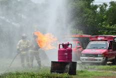 This is a drill: Firefighters extinguish flames during a fire prevention and response training session in Madiun, East Java, on Nov. 5, 2025. The exercise, joined by members of the Madiun Fire and Rescue Department, honed their skills and sharpened their readiness to handle emergencies.