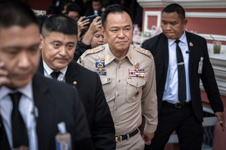 Thailand's Prime Minister Anutin Charnvirakul (center) walks after chairing a National Security Council (NSC) meeting at the Government House in Bangkok on November 11, 2025. Thailand on November 11 reinstated its suspension of a peace agreement with neighboring Cambodia after a landmine blast wounded four soldiers near the border, the Thai army said. 