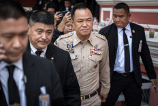 Thailand's Prime Minister Anutin Charnvirakul (center) walks after chairing a National Security Council (NSC) meeting at the Government House in Bangkok on November 11, 2025. Thailand on November 11 reinstated its suspension of a peace agreement with neighboring Cambodia after a landmine blast wounded four soldiers near the border, the Thai army said. 