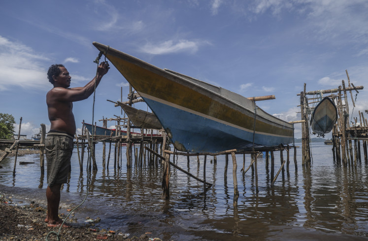 A fisherman parks his fishing boat on Nov. 11, in Kupal village, on Bacan Island, at coastal area in South Halmahera regency, North Maluku. 