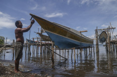 A fisherman parks his fishing boat on Nov. 11, in Kupal village, on Bacan Island, at coastal area in South Halmahera regency, North Maluku. 