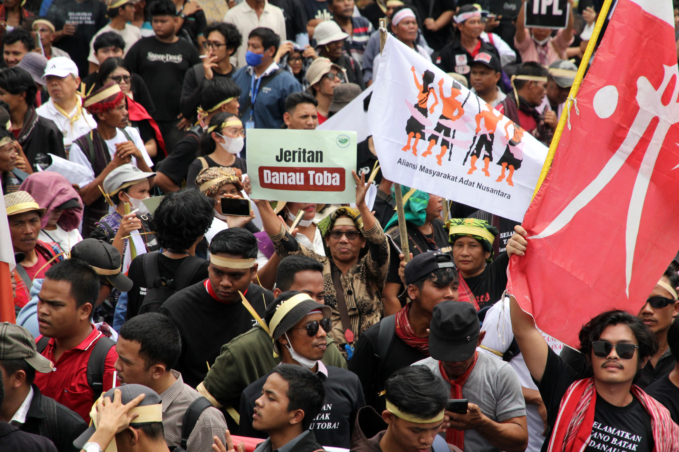 A group of Batak community members hold posters during a protest on Nov. 10 in front of the North Sumatra Governor’s office in Medan. They demanded that governor Bobby Nasution shut down PT Toba Pulp Lestari (TPL), accusing the company of grabbing indigenous land and causing ecological damage around Lake Toba.