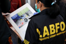 Forensic officers prepare a picture showing a toy firearm and other evidence lying on the ground where explosions occurred at a mosque inside a school complex during Friday prayers last week, during a press conference at Jakarta Police headquarters in on Nov. 11, 2025.