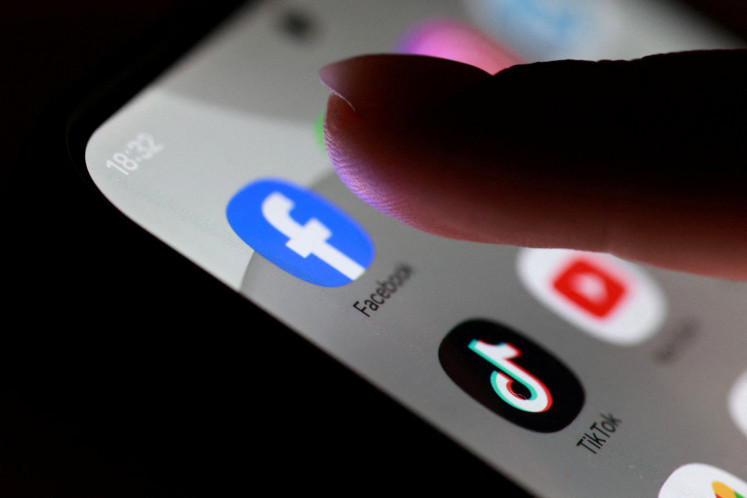 Swipe no more: The Facebook, TikTok and YouTube app icons are seen on a smartphone in this photo taken on Oct. 27.