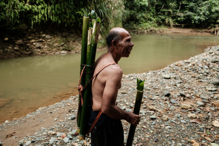 One man show: Ngigoro, 62, an elder of the O’Hongana Manyawa indigenous tribe who left the forest and now lives in a village with his mother, stands beside an allegedly contaminated river on April 16, 2025 in East Halmahera, North Maluku.