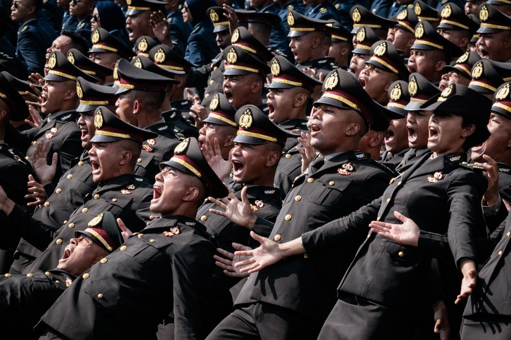 New police officers perform during a commissioning ceremony on July 23, 2025, for around 2,000 graduates from military and police academies at the Presidential Palace in Jakarta.