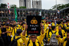 A university student holds a poster on Aug. 29, 2025, during a protest against police brutality in front of the Jakarta Metropolitan Police headquarters in Kebayoran Baru, South Jakarta.