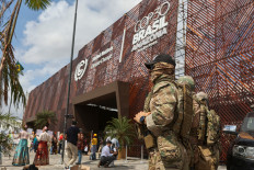 Brazilian federal police officers stand guard near the entrance of the venue hosting the UN Climate Change Conference, or COP30, in Belem, Brazil, on Nov. 12, 2025 a day after Indigenous protesters stormed the entrance and clashed with guards while demanding climate action and protection for the Amazon forest.