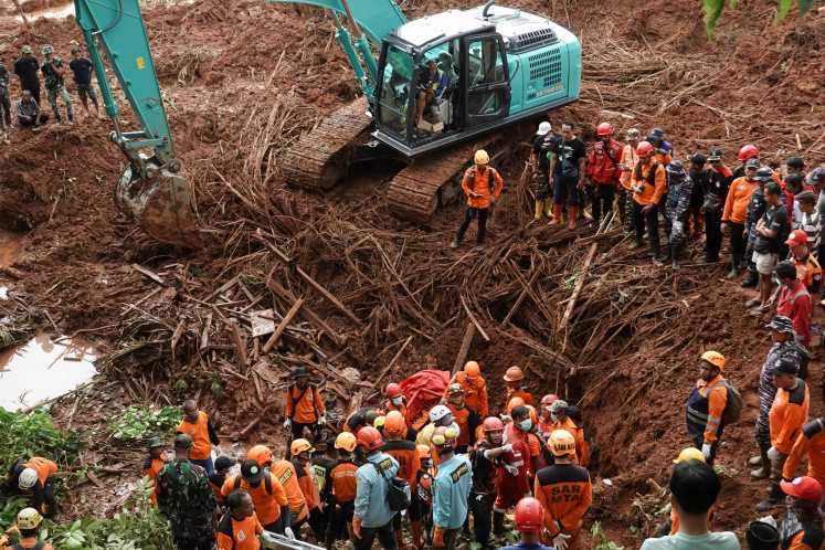 Rescue members search for victims at the site of a landslide, which hit Cibeunying village on November 13, in Cilacap, Central Java, November 15, 2025.