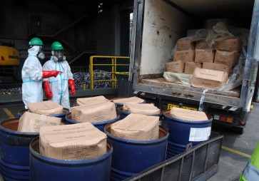 Workers wearing personal protective equipment prepare to destroy cardboard boxes containing shrimp contaminated with radioactive materials on Nov. 15, 2025, at PT Prasadha Pamunah Limbah Industri (PPLI) in Klapanunggal, Bogor, West Java. The Environment Ministry has destroyed 5.7 tonnes of shrimp contaminated with the radioactive isotope Cesium-137 (Cs-137) from Cikande in Serang, Banten, through a gradual incineration process.