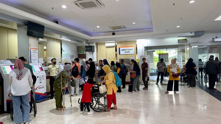 Patients wait in long queues on Sept. 16 at a hospital registration counter in a public medical facility in Jakarta.