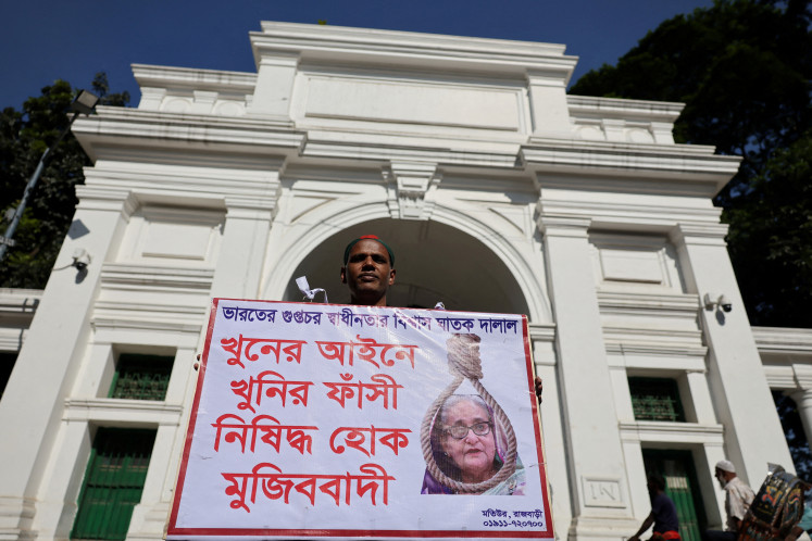 A man holds a poster in front of the court demanding the capital punishment on Monday ahead of a verdict on charges of crimes against humanity against ousted Bangladesh prime minister Sheikh Hasina for a deadly 2024 crackdown on student-led protests in Dhaka.