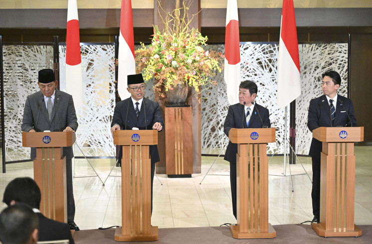 Japanese and Indonesian foreign and defense ministers hold a joint press conference in Tokyo on Nov. 17, following their meeting. (Kyodo/Pool)