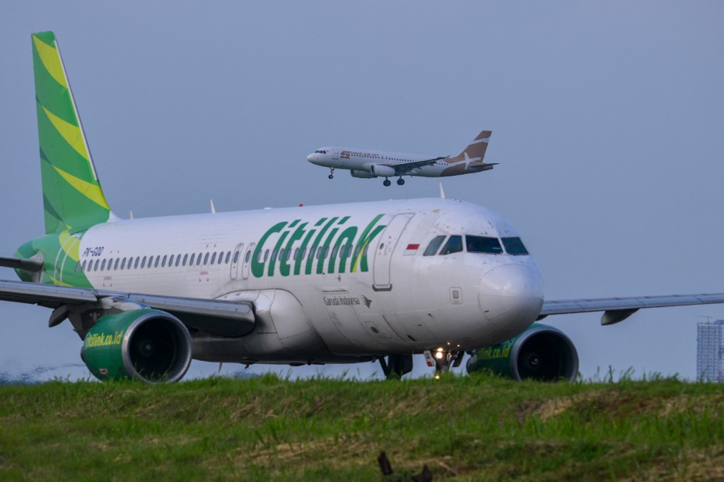 An aircraft operated by low-cost carrier Citilink, a subsidiary of national airline Garuda Indonesia, taxis as a Super Air Jet comes in for a landing on Jan. 10, 2025, at Soekarno-Hatta International Airport in Tangerang, Banten.
