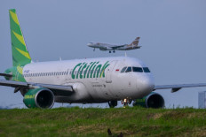 An aircraft operated by low-cost carrier Citilink, a subsidiary of national airline Garuda Indonesia, taxis as a Super Air Jet comes in for a landing on Jan. 10, 2025, at Soekarno-Hatta International Airport in Tangerang, Banten.