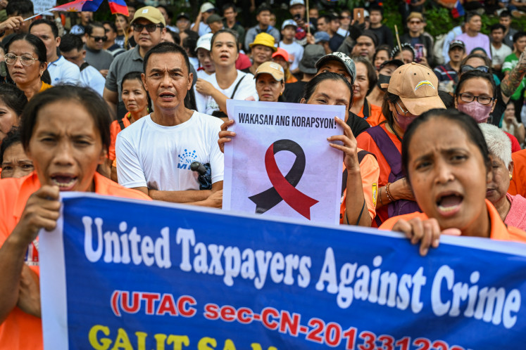 Protesters march on Nov. 16, 2025, during an anti-corruption rally in Quezon City, the Philippines.