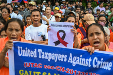 Protesters march on Nov. 16, 2025, during an anti-corruption rally in Quezon City, the Philippines.