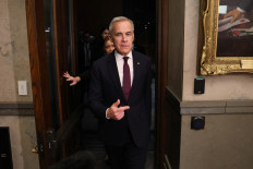 Safe passage: Canadian Prime Minister Mark Carney gestures on Monday, Nov. 17, while leaving the Question Period at the House of Commons on Parliament Hill in Ottawa.