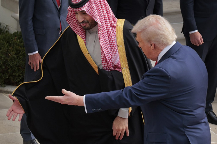US President Donald Trump (right) welcomes Crown Prince and Prime Minister Muhammad bin Salman of Saudi Arabia during an arrival ceremony at the White House on November 18, 2025 in Washington, DC. 