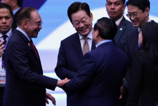 South Korea's President Lee Jae-myung (center) and Malaysia's Prime Minister Anwar Ibrahim (left) speak with Vietnam's Prime Minister Pham Minh Chinh (center right) on Oct. 27 during the 26th ASEAN - South Korea Summit at the 47th ASEAN Summit in Kuala Lumpur, Malaysia.