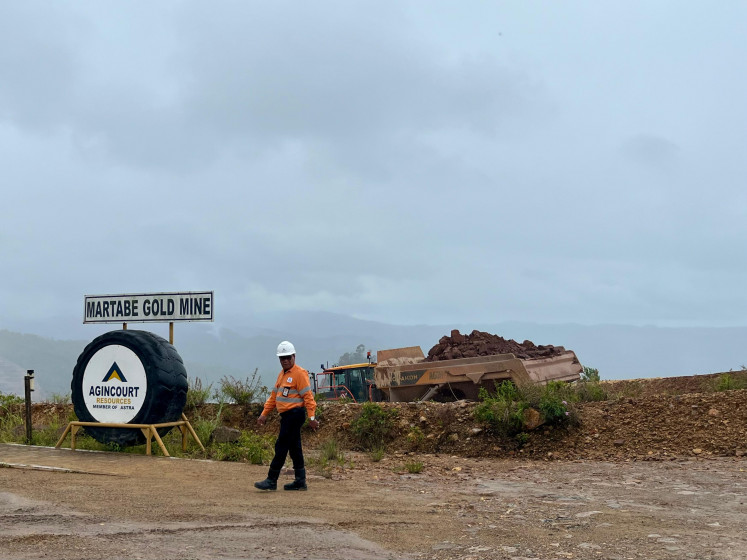 A worker walks across an operational area at the Martabe gold mine in Batang Toru district's South Tapanuli, North Sumatra. The mine is operated by PT Agincourt Resources, a unit of Indonesian conglomerate PT Astra International.