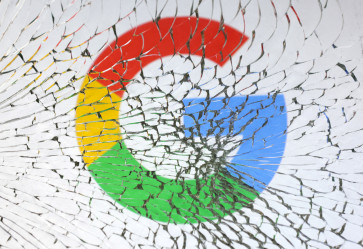 The Google logo is seen through broken glass in this illustration photo created on Jan. 25, 2023.