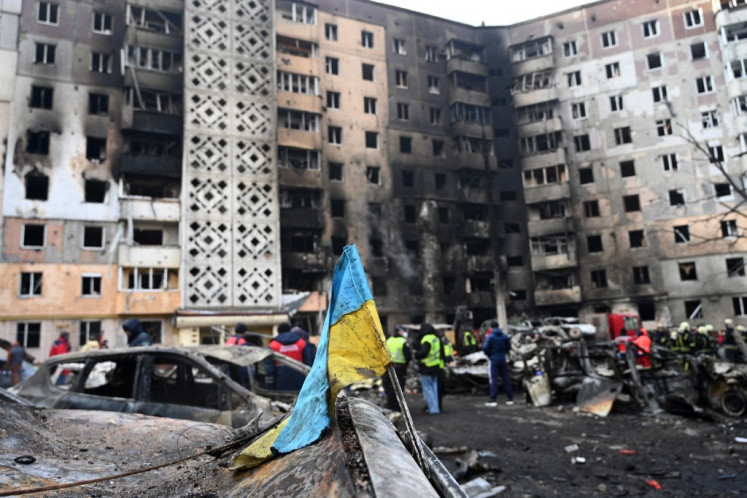 A Ukrainian flag is seen attached to a burned car at the site of a heavily damaged residential building following Russian air strike in the city of Ternopil, Ukraine, on Nov. 19, 2025, amid the Russian invasion of Ukraine. The number of people killed in a Russian missile and drone strike on the western Ukrainian city of Ternopil rose to 25, including three children, the interior ministry said Nov. 19.