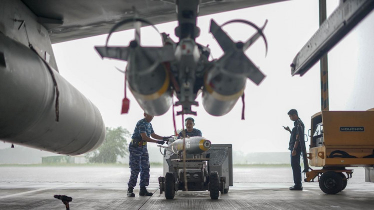 Air Force armorers load BNT-250 live bombs onto an F-16 AM from the 3rd Air Squadron at the Iswahjudi Air Force Base in Maospati, Magetan regency, East Java, on Nov. 18, 2025. The NATO-standard bomb is locally made by private arms maker PT Sari Bahari in cooperation with state-owned explosives maker PT Dahana. 