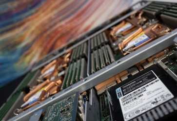 A display shows copper covered CPU's and cooling coils from a Lenovo server at the Digital Realty Innovation Lab (DRIL) data center in Ashburn, Virginia, US, on Nov. 12, 2025.