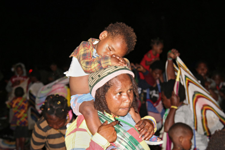 Papuans who fled their villages due to fighting near the Grasberg gold and copper mine on March 9, 2020, gather at a makeshift shelter in Timika. An Indonesian soldier was killed on March 9 in a shootout with rebels in Papua, prompting more than a thousand civilians to flee fighting near the world's biggest gold mine.