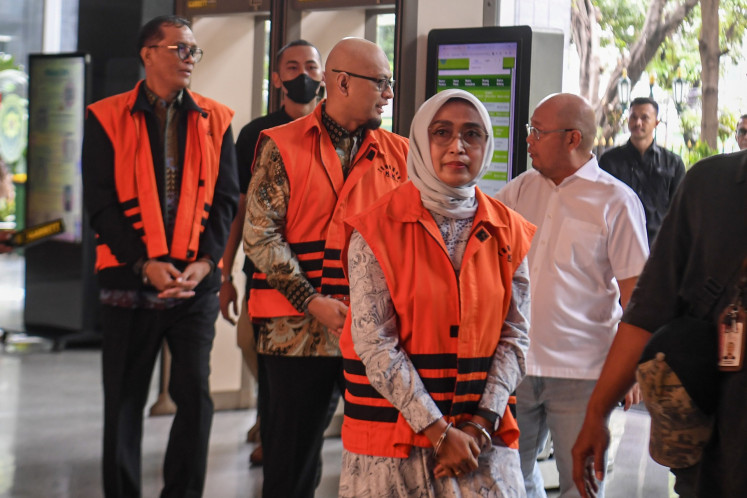 Former State-owned ferry operator PT ASDP Ferry Indonesia president director Ira Puspadewi (second right), planning and development director Harry Muhammad Adhi Caksono (third left) and commercial and service director Muhammad Yusuf Hadi (left) walk into the Jakarta Corruption Court on Nov. 20 ahead of their verdict hearing. The three defendants, who were indicted for corruption that caused Rp 1.25 trillion (US$75 million) in state losses in the acquisition of PT Jembatan Nusantara, were found guilty by the court.