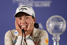 Jeeno Thitikul of Thailand with the CME Group trophy as she speaks to the media after her win during the final round of the CME Group Tour Championship 2025 at Tiburon Golf Club on Nov. 23, 2025, in Naples, Florida, the United States. 