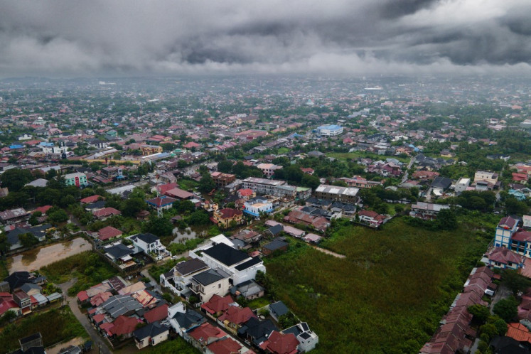 This aerial picture show a general view of residential houses under clouds following heavy rain at Darul Imarah on the outskirts of Banda Aceh on November 27, 2025.