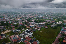 This aerial picture show a general view of residential houses under clouds following heavy rain at Darul Imarah on the outskirts of Banda Aceh on November 27, 2025.