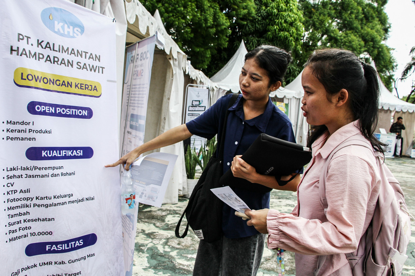Paycheck pursuers: Visitors look for job vacancy information on Nov. 28, 2025, at a job fair at the University of Palangka Raya in Central Kalimantan.
