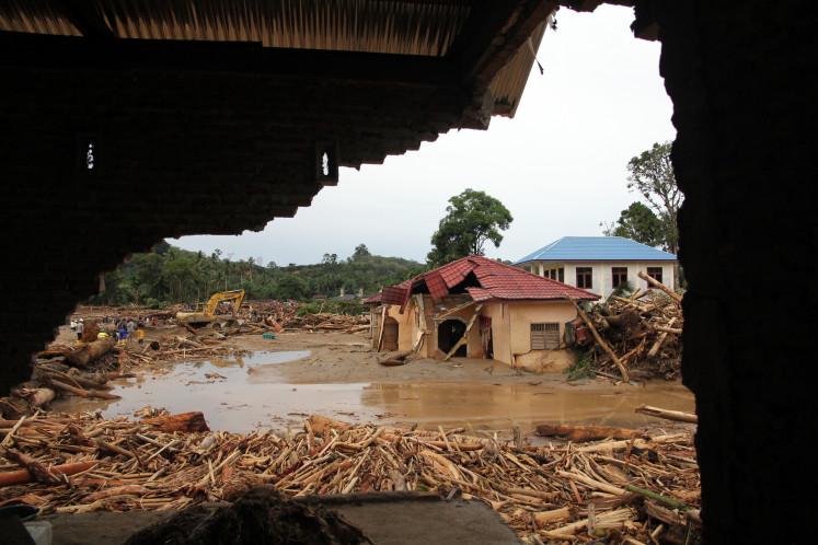 Damaged houses are seen on Nov. 28, 2025, after a flash flood in Batang Toru district, South Tapanuli regency, North Sumatra.