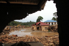 Damaged houses are seen on Nov. 28, 2025, after a flash flood in Batang Toru district, South Tapanuli regency, North Sumatra.