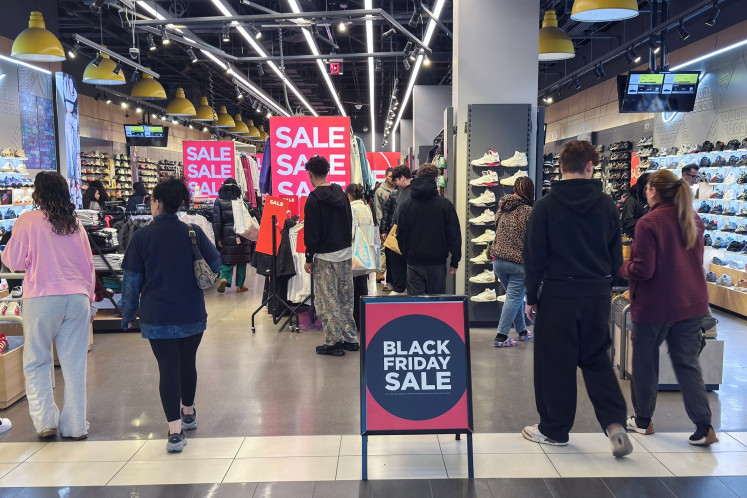 People shop during Black Friday sales, a post Thanksgiving shopping frenzy that attracts throngs of bargain hunters to stores, at the Roosevelt Field mall in Garden City, New York, the United States, on Nov. 28, 2025.