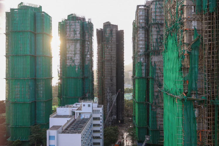 Charred remains of multiple residential towers following a deadly fire on Wednesday at Wang Fuk Court housing complex in Tai Po, Hong Kong, on Nov. 29, 2025.