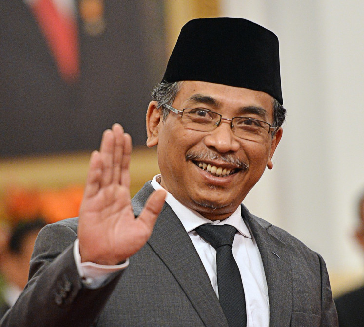 Indonesia's largest Islamic organization Nahdlatul Ulama (NU) Yahya Cholil Staquf greets journalists after his inauguration as a member of the Presidential Advisory Board (Wantimpres) at the State Palace in Jakarta on May 31. 